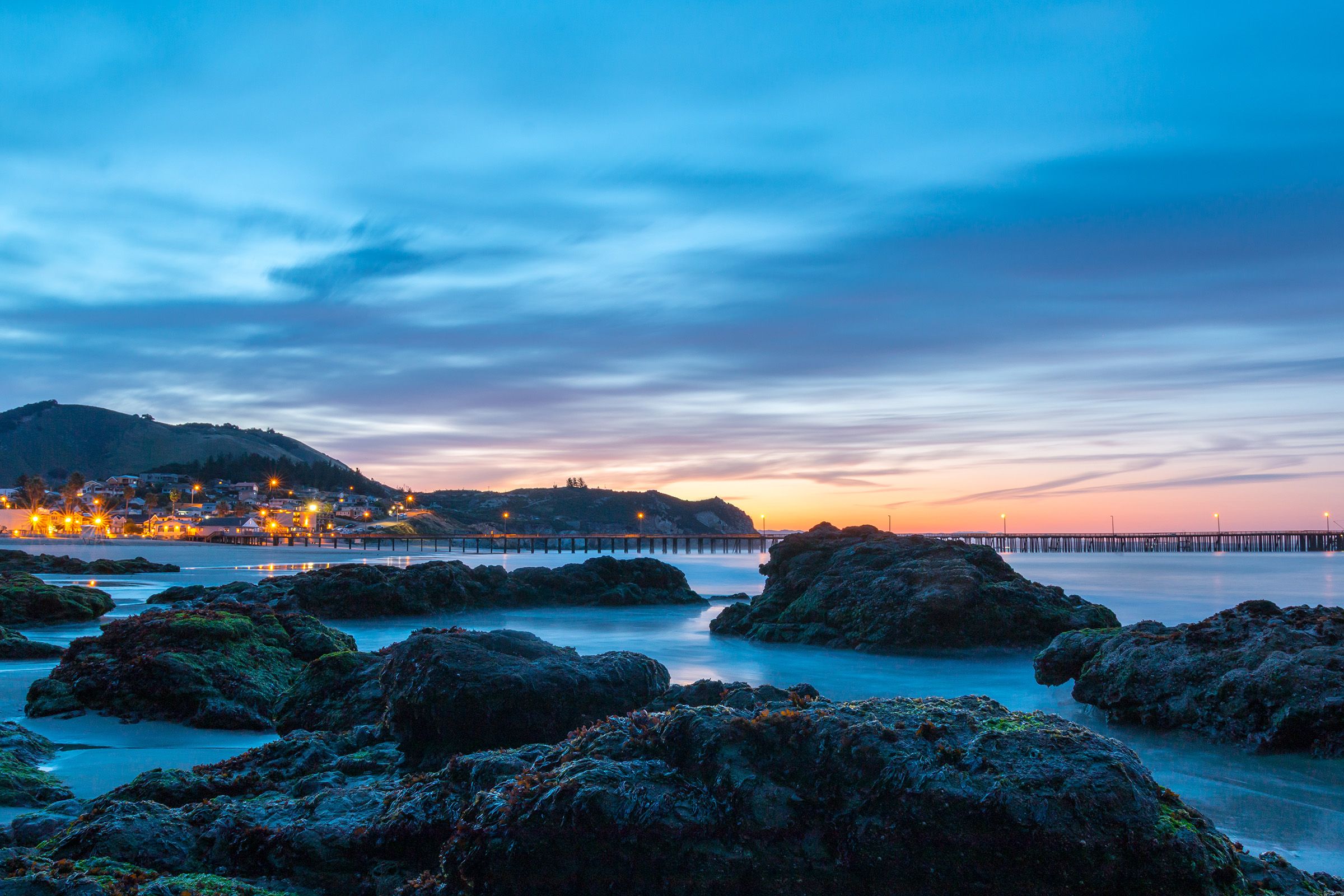 Rocks along the shore of Avila Beach at blue hour before sunrise