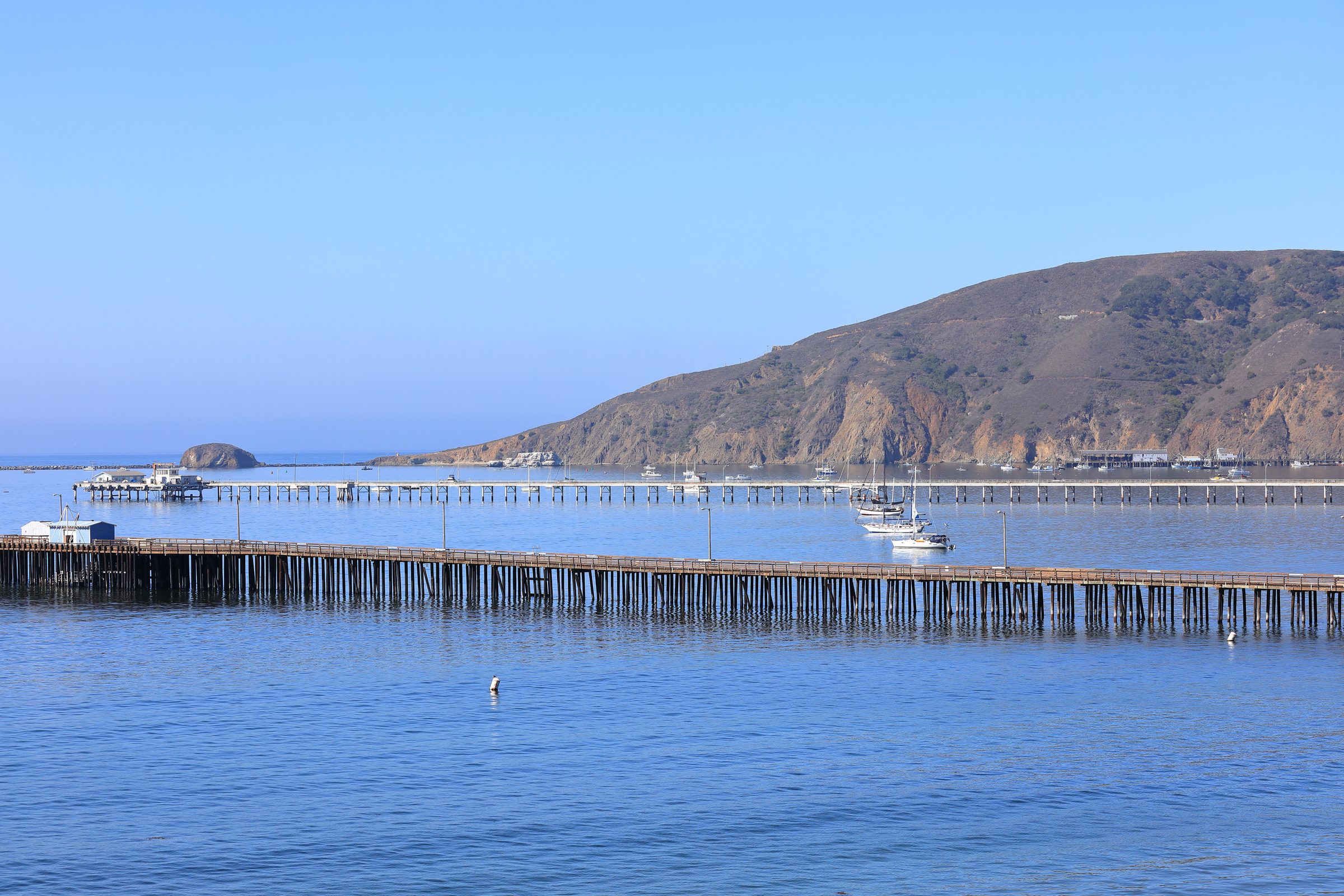 Avila Pier and Cal Poly Pier on a clear day, with Point San Luis and Harford Pier beyond