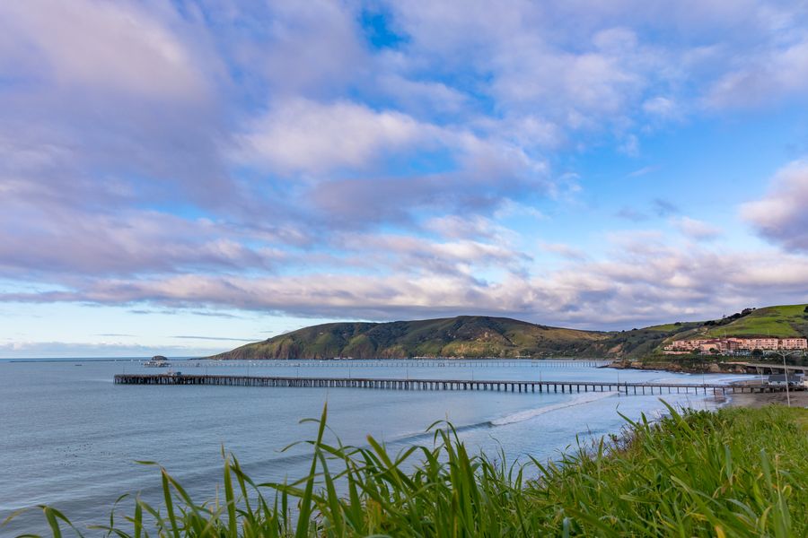 Clouds over San Luis Bay, with Avila Pier, Cal Poly Pier and Port San Luis from the grassy bluff