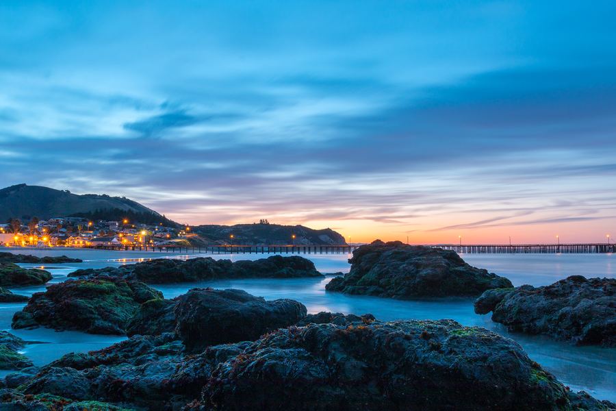 Rocks along the shore of Avila Beach at blue hour before sunrise