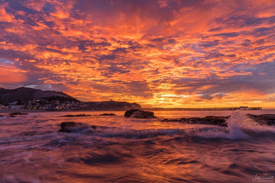 Fiery orange sky over breaking waves in Avila Beach