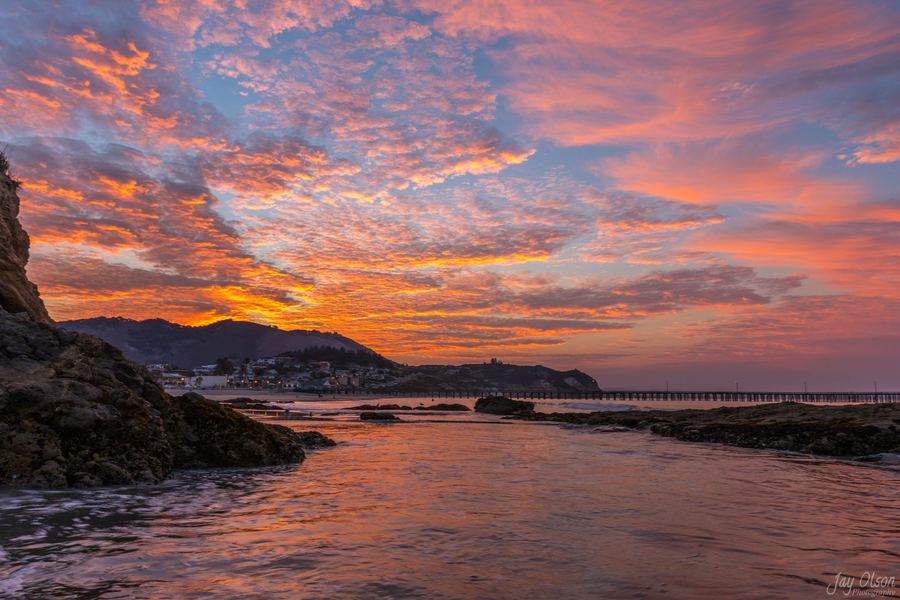 Orange clouds reflected in a tide pool at Avila Beach