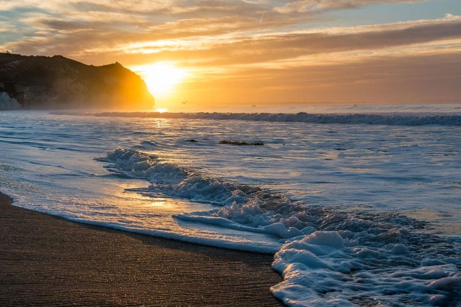 Surf rolling in at sunrise in Avila Beach